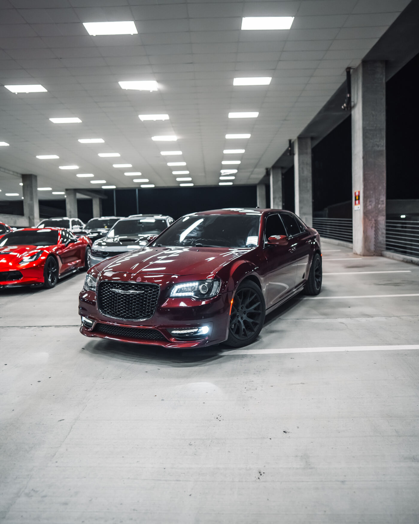 Maroon Chrysler 300 front three-quarter in parking deck